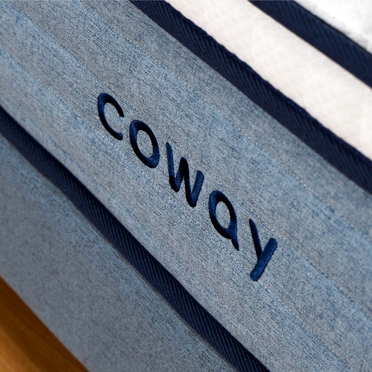 A Close Up View Of The Coway Logo On The Coway Prime Lite Series Mattress - Coway Prime Lite Series