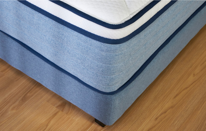 High View Of The Coway Prime Lite Series Mattress On A Wooden Floor Featuring Its Round Corner - Coway Prime Lite Series