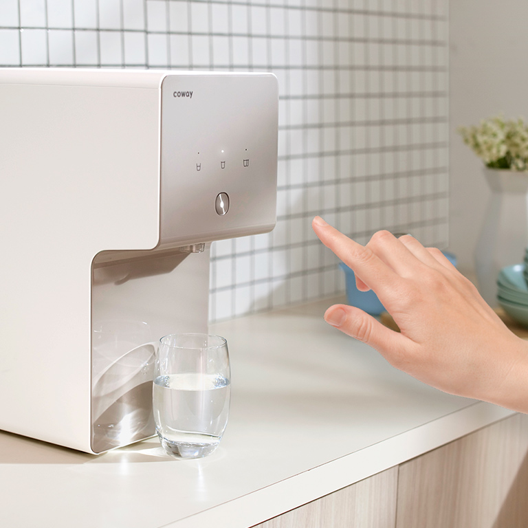 Touch Panel Of Home Water Purifier Being Activated By A Hand - Coway Cinnamon