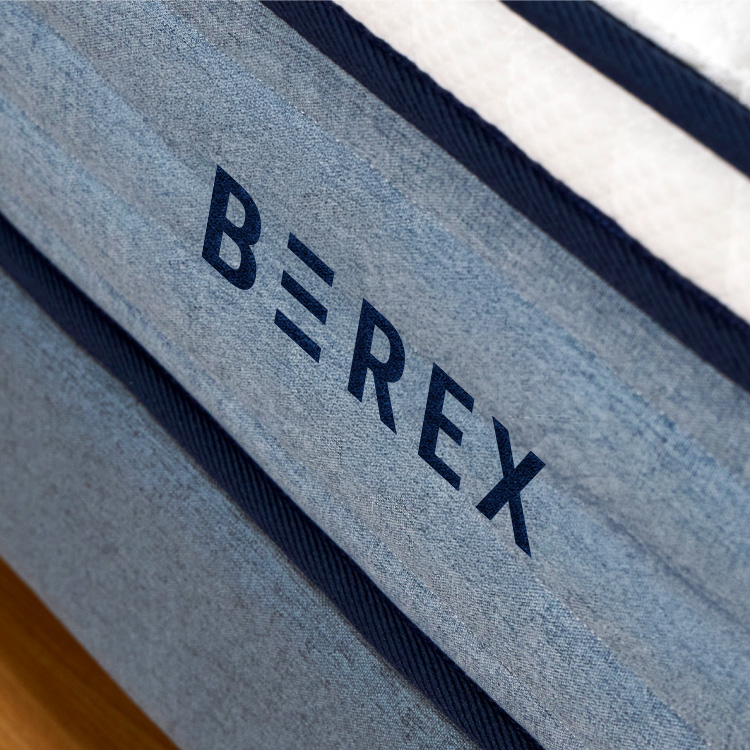 A Close Up View Of The Coway Logo On The Coway Prime Lite Series Mattress - Coway Prime Lite Series