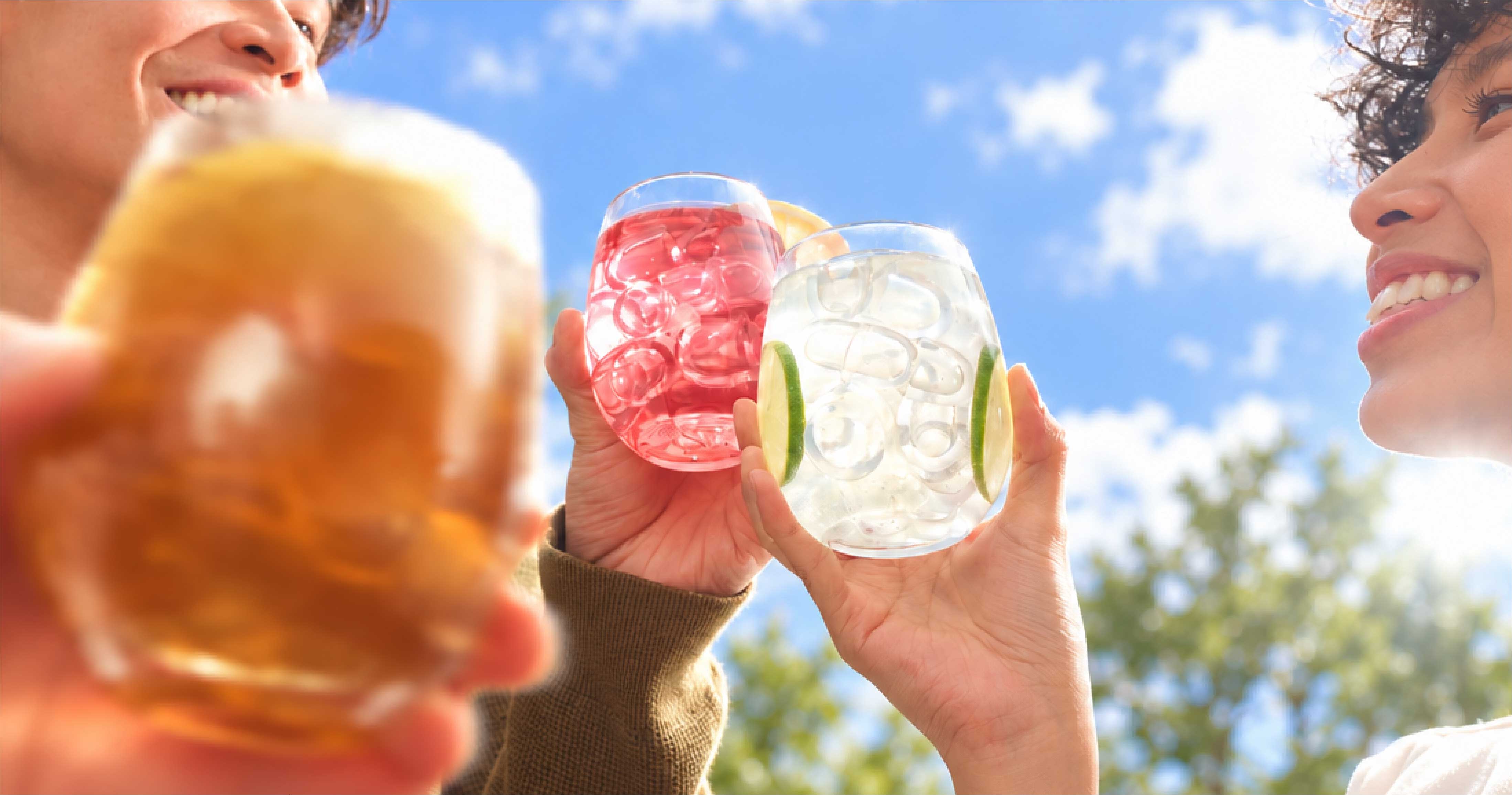 Friends sharing iced drinks